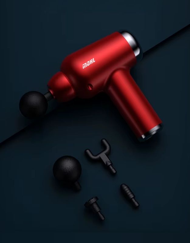 A red portable deep tissue percussive muscle mini gun massager with multiple attachments, displayed on a dark background.
